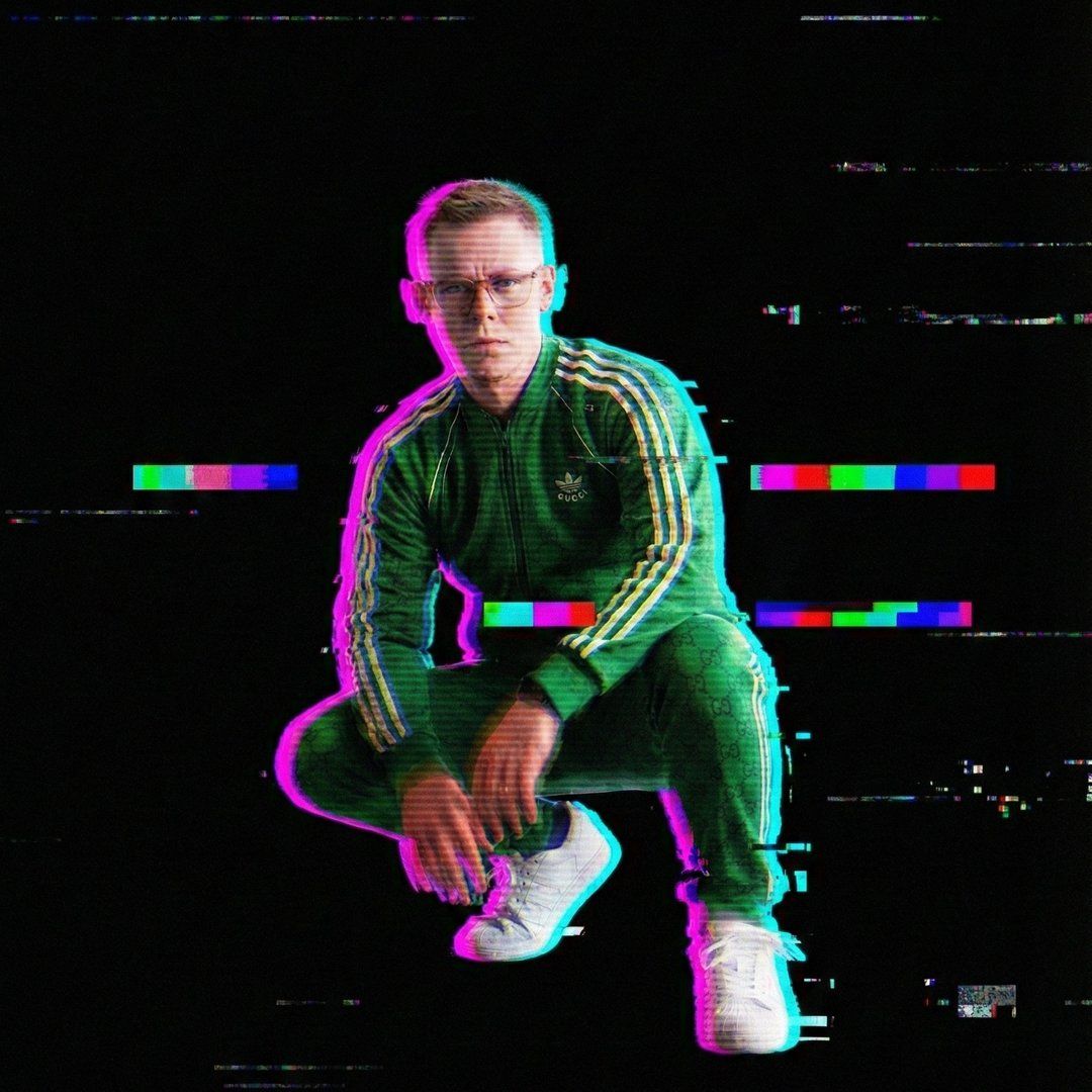 Jonathan Fager, crouched, in a green tracksuit — the photo run through a chromatic-split glitch filter